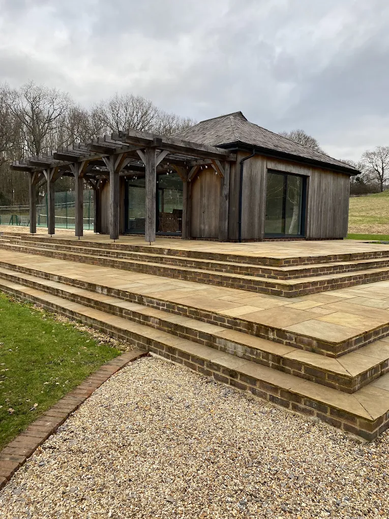 Barn-style outbuilding with timber pergola